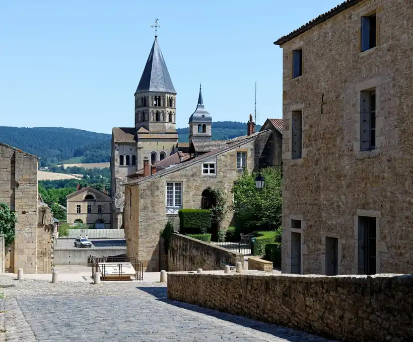 The town of Cluny below the abbey bell tower, seen from a cobbled street